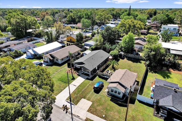 drone / aerial view with a forest view and a residential view