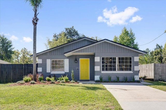 view of front of property with a front yard and fence