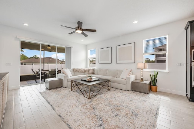 living room with recessed lighting, light wood-style flooring, baseboards, and ceiling fan