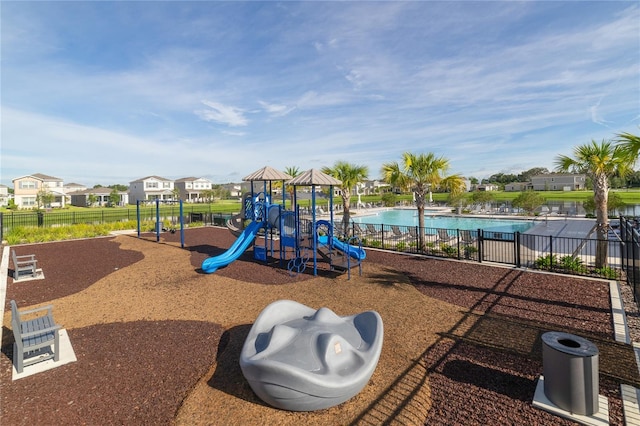 communal playground with a community pool and fence