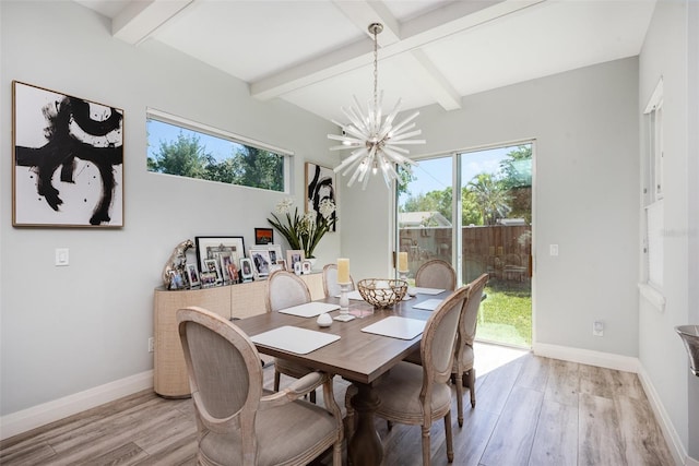 dining area featuring a notable chandelier, plenty of natural light, light wood-type flooring, and baseboards