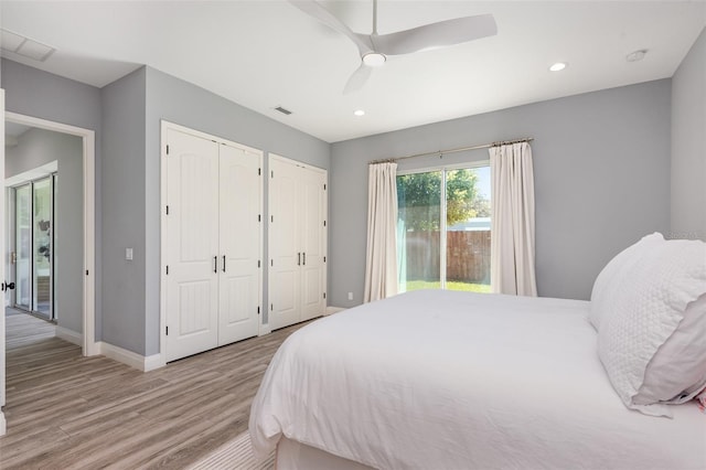 bedroom with light wood finished floors, access to exterior, baseboards, multiple closets, and recessed lighting