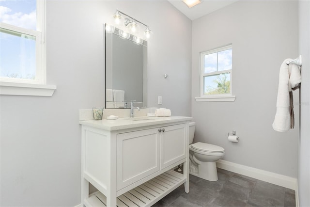 bathroom featuring baseboards, toilet, and vanity