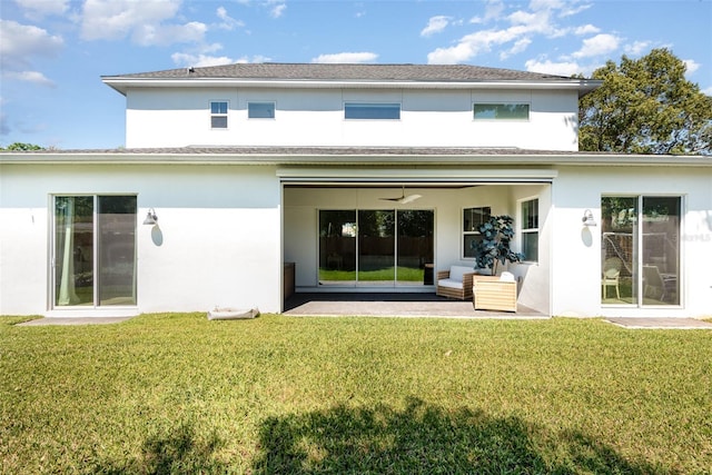 back of house featuring ceiling fan, stucco siding, outdoor lounge area, a yard, and a patio