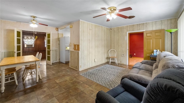 living area featuring a ceiling fan and ornamental molding