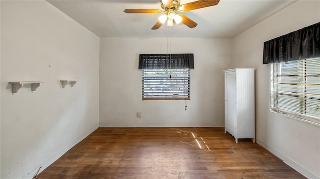 empty room with baseboards, a ceiling fan, and wood finished floors