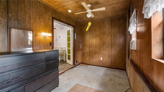 bedroom featuring ceiling fan, wooden walls, marble finish floor, and wooden ceiling