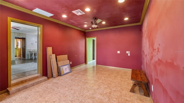 unfurnished room with ornamental molding, baseboards, visible vents, and ceiling fan