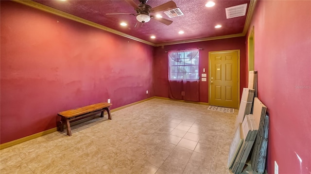 interior space with visible vents, baseboards, and ornamental molding