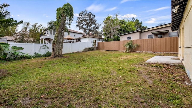 view of yard with a fenced backyard