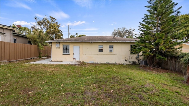 back of house with a patio area, cooling unit, a lawn, and a fenced backyard