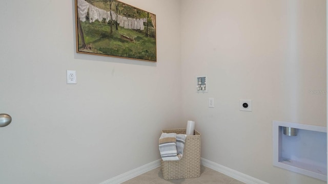 clothes washing area with baseboards, laundry area, hookup for a washing machine, tile patterned floors, and electric dryer hookup