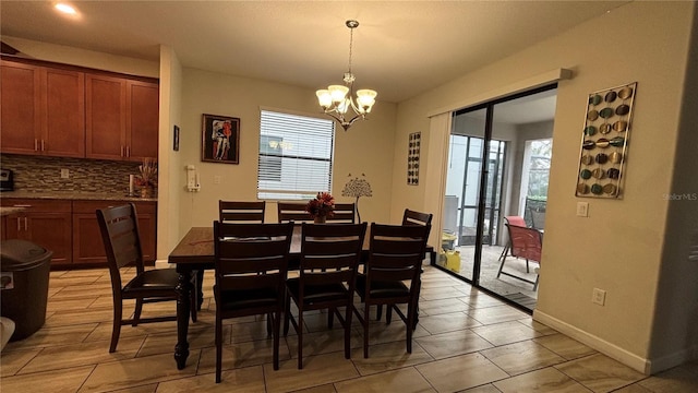 dining area with a notable chandelier and baseboards