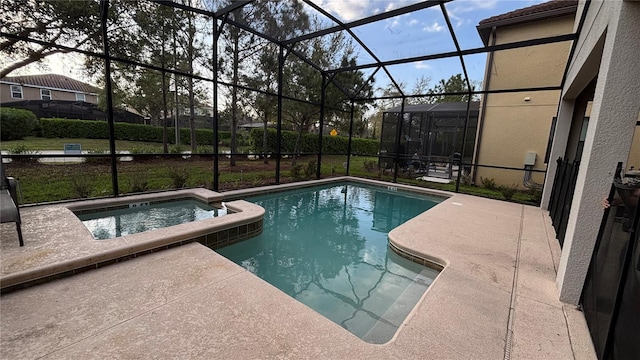 view of swimming pool with a patio area, glass enclosure, and a pool with connected hot tub