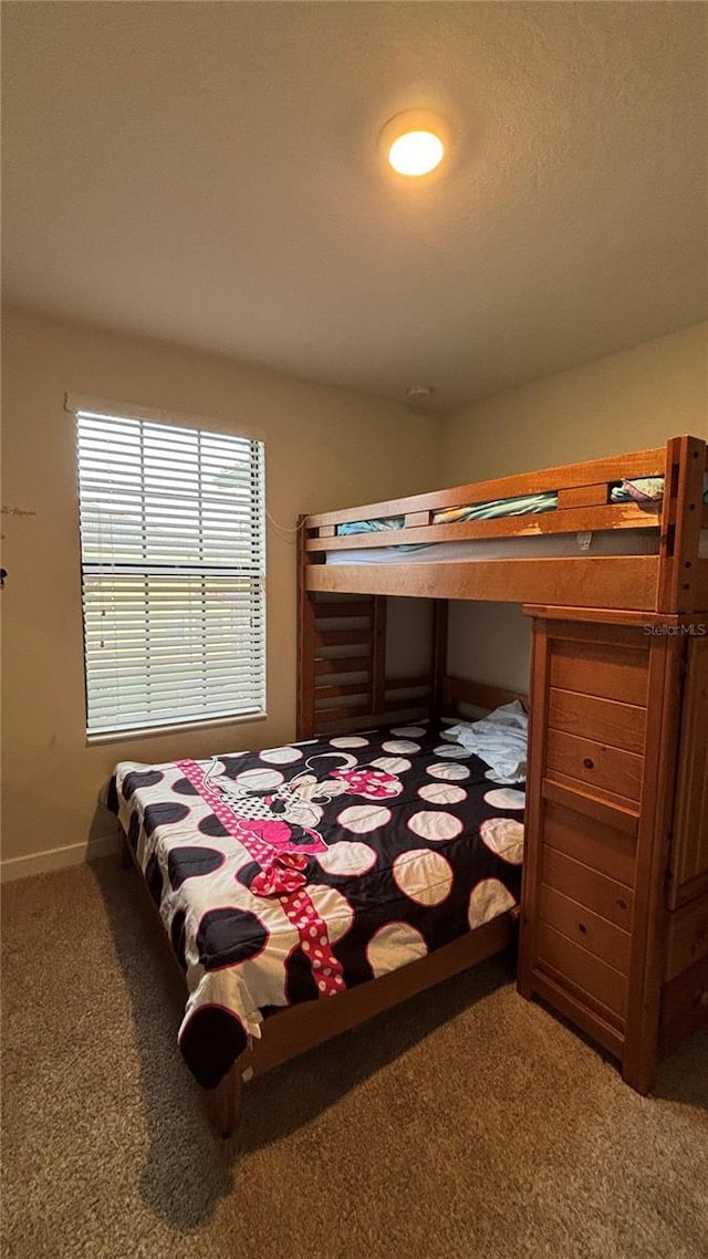 bedroom with carpet flooring and baseboards