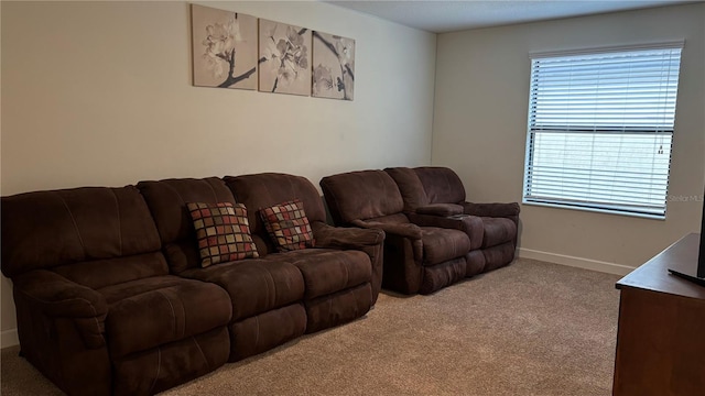 living area with baseboards and carpet