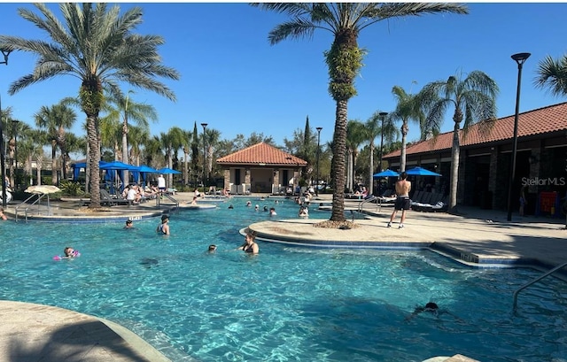 pool with a gazebo and a patio