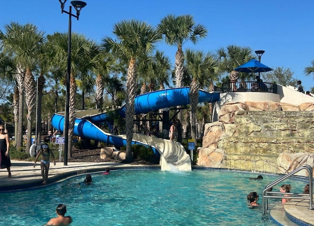 community pool featuring a water slide