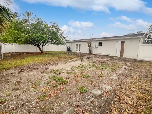 rear view of property with a fenced backyard