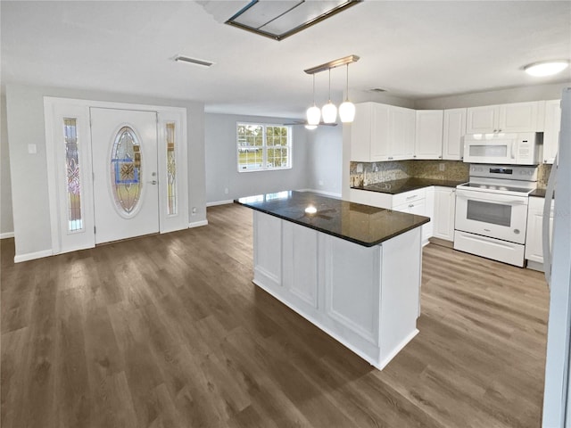 kitchen with white appliances, visible vents, dark wood finished floors, white cabinets, and dark countertops