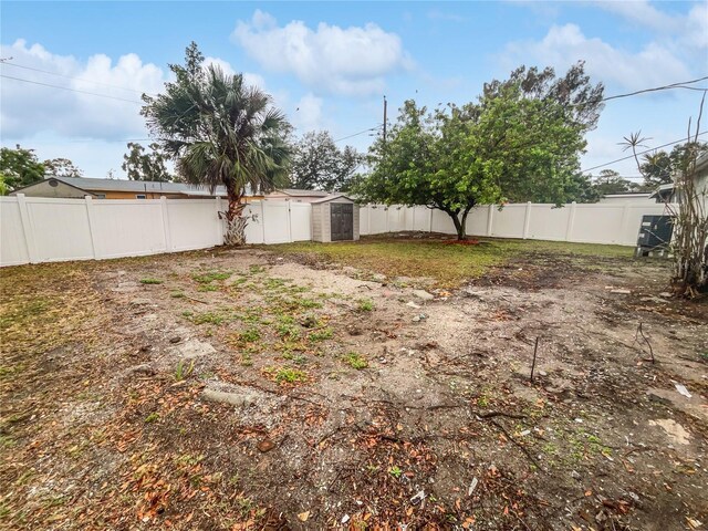 view of yard featuring a fenced backyard, a shed, and an outdoor structure