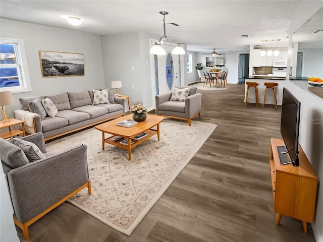 living area with visible vents and dark wood-style flooring