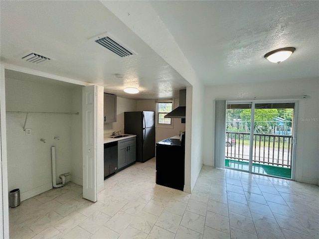 kitchen featuring visible vents, marble finish floor, black appliances, and a sink