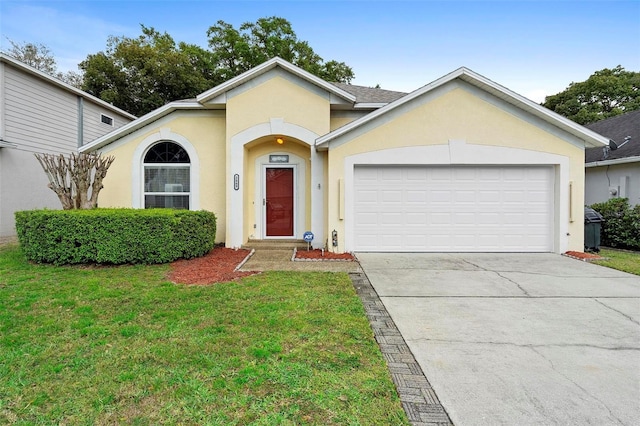 ranch-style home with a front yard, an attached garage, driveway, and stucco siding