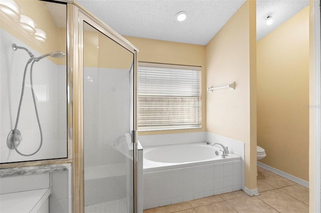 bathroom with a garden tub, toilet, and a stall shower