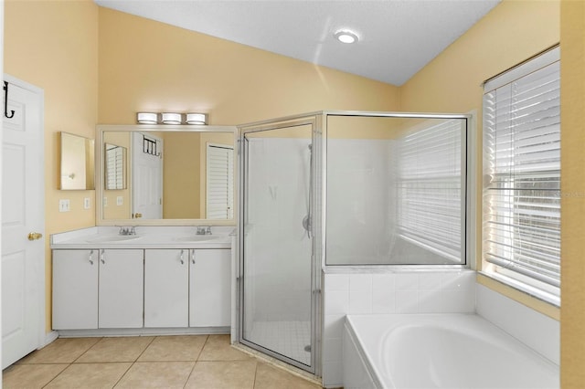 full bath with a garden tub, a stall shower, a sink, tile patterned flooring, and lofted ceiling