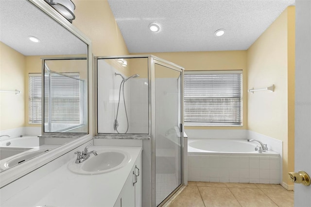 full bathroom featuring a textured ceiling, a shower stall, and tile patterned flooring