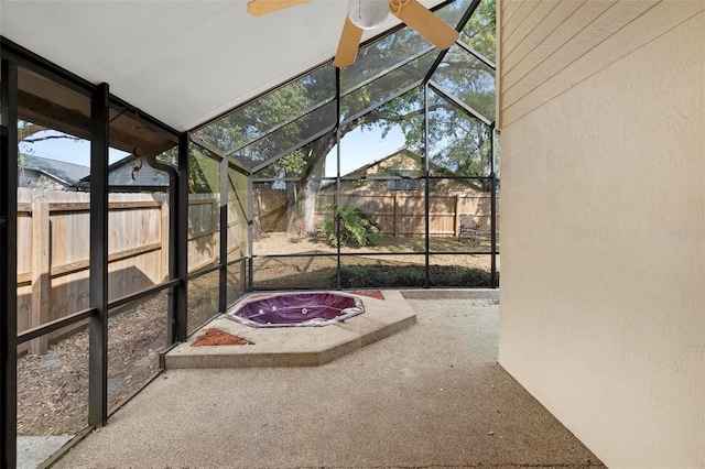 unfurnished sunroom with ceiling fan