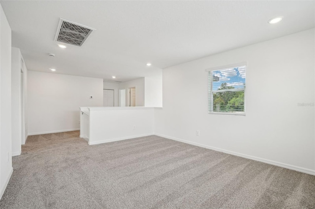 unfurnished room with light carpet, baseboards, visible vents, and recessed lighting