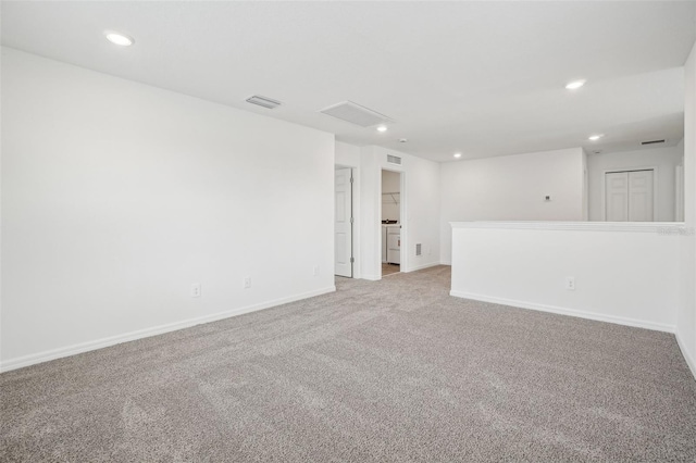 carpeted spare room with visible vents, baseboards, and recessed lighting