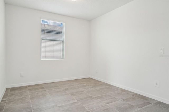 spare room with baseboards