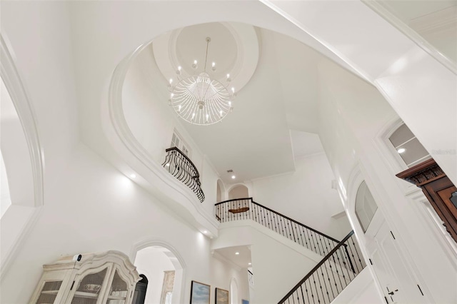 interior space featuring a chandelier and a towering ceiling