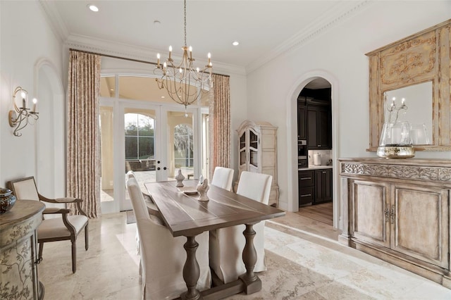 dining space featuring recessed lighting, arched walkways, a notable chandelier, and crown molding