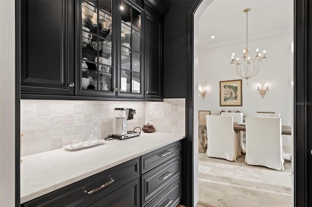 bar with arched walkways, decorative backsplash, hanging light fixtures, and an inviting chandelier