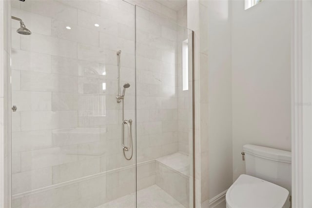 full bathroom with a shower stall and toilet