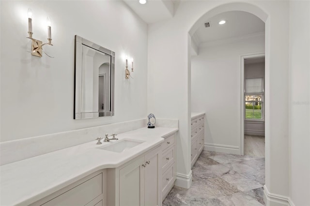 bathroom featuring visible vents, crown molding, baseboards, recessed lighting, and vanity