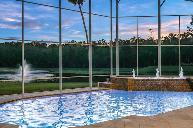 view of pool featuring a lanai and a water view