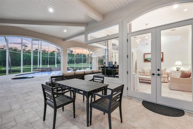 sunroom featuring french doors and lofted ceiling with beams