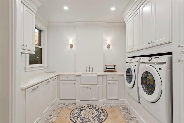 laundry area featuring ornamental molding, a sink, washing machine and dryer, recessed lighting, and cabinet space