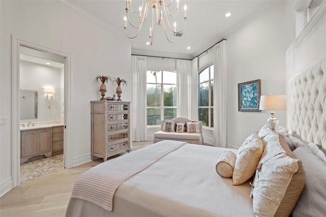 bedroom featuring light wood finished floors, ensuite bath, recessed lighting, a sink, and a notable chandelier