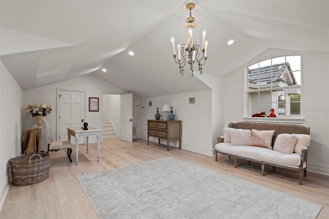 interior space featuring a notable chandelier, light wood-style flooring, visible vents, and lofted ceiling