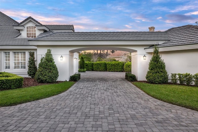 view of parking / parking lot with driveway and a garage