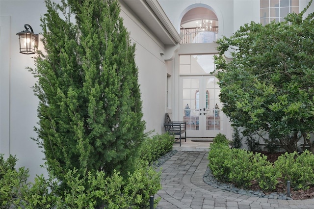 doorway to property featuring stucco siding and french doors