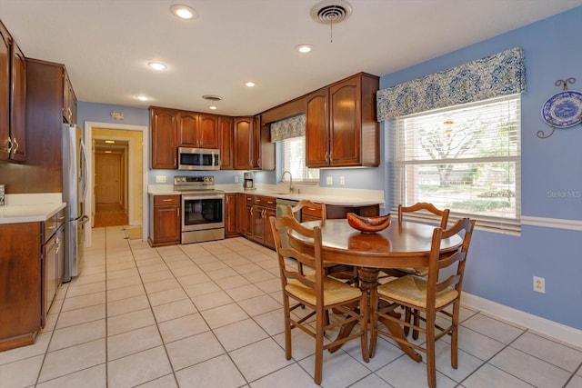 kitchen featuring a sink, visible vents, appliances with stainless steel finishes, and light countertops