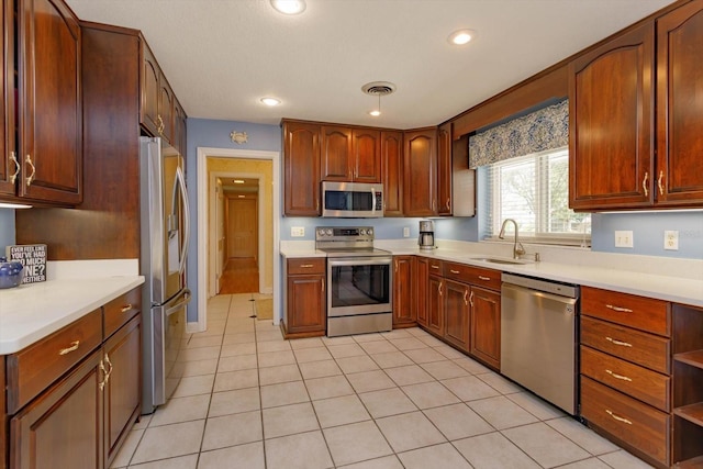 kitchen with visible vents, appliances with stainless steel finishes, light countertops, and a sink