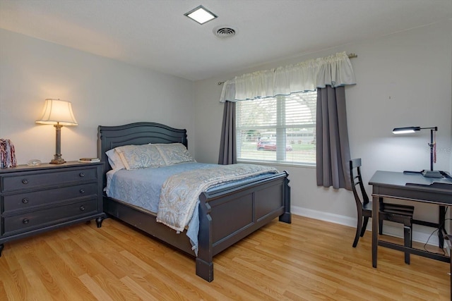 bedroom featuring visible vents, baseboards, and light wood-style flooring